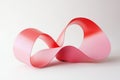 undulating ribbon in light pink and red, gently moving in continuous loops, evoking a sense of