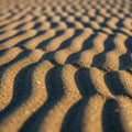 Fine sand create a mesmerizing pattern accentuated by the play of Royalty Free Stock Photo