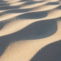 Undulating sand dunes create a pattern of light and shadow, with a soft texture and fine Royalty Free Stock Photo