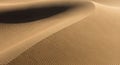 Undulating sand dunes feature intricate patterns created by wind, with fine ripples and smooth Royalty Free Stock Photo