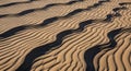 Undulating sand patterns create a mesmerizing design on the desert floor. The ripples, formed by Royalty Free Stock Photo