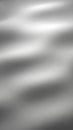 Smooth, undulating metallic surface with soft, diffused light creating gentle waves and subtle reflections Keywords: metallic, Royalty Free Stock Photo