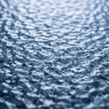 Undulating texture resembling water surface or patterned glass, with a blue-gray hue. The surface Royalty Free Stock Photo