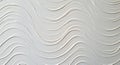 Undulating wave patterns in white plaster form a textured decorative surface. The Royalty Free Stock Photo