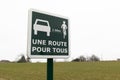 Une route pour tous french text means road sharing cars and bikes Royalty Free Stock Photo