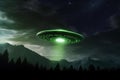 Unearthly sighting, UFO spaceship in dramatic night sky, green creature nearby Royalty Free Stock Photo