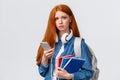 Uneasy, upset and gloomy cute redhead teenage girl, student in university frowning look distressed and unhappy camera