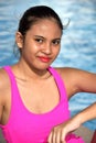 Unemotional Teenager Girl Sitting By Pool