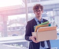 Unemployed Business man carrying a packed box with upset expression for Economic recession concept Royalty Free Stock Photo