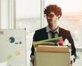 Unemployed Business worker carrying a packed box walking out of office with upset expression for unemployment concept Royalty Free Stock Photo