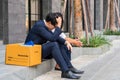 Unemployed man, The economic downturn made people unemployed, Desperate businessman sitting hopelessly on stair in central Royalty Free Stock Photo