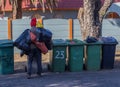 Unemployed man searching through rubbish bins