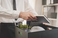 Unemployed, quite job. Desperate caucasian young businessman resigning from company, hand holding stuffs into the cardboard,