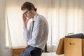 Unemployed, quite job. Desperate caucasian young businessman resigning from company, packing belongings, stuff in box cardboard, Royalty Free Stock Photo