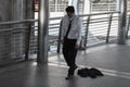 Unemployed stressed young Asian business man sitting on floor outdoors. Failure and layoff concept