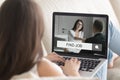 Woman lying on couch with laptop, trying to find job. Royalty Free Stock Photo