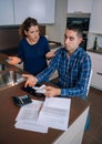 Unemployed young couple with debts reviewing their Royalty Free Stock Photo