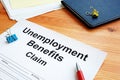 Unemployment benefits claim and stack of papers