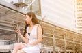 Unemployment problem concept,Asian beautiful woman connection internet find new job on cell phone while sitting outdoor