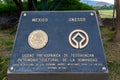 UNESCO sign at the Ruins of the architecturally significant Mesoamerican pyramids and green grassland located at at Teotihuacan,