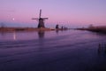 UNESCO World Heritage windmill stands in the evening light in Kinderdijk, near Rotterdam Netherlands Royalty Free Stock Photo