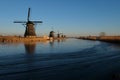 UNESCO World Heritage windmills stand as waters are partially frozen in Kinderdijk, near Rotterdam Netherlands Royalty Free Stock Photo