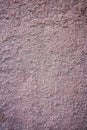Uneven pink plaster covered shabby old wall, horizontal cracked background, rough abstract surface texture