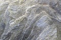 Uneven, rough, irregular granite stone surface. Natural textured relief grey background.