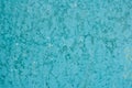 Unevenly colored surface with spots. Blue background with paint spots. Painted wall texture