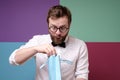 Unexpected gift. Bearded man in round glasses, received an unexpected pleasant surprise looking impatiently at what is Royalty Free Stock Photo