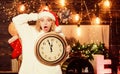 Unexpectedly soon. Midnight concept. Make wish. Woman Santa hat hold vintage clock. Time to celebrate. Merry christmas