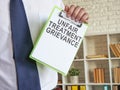 Unfair treatment grievance with clipboard in the hands. Royalty Free Stock Photo