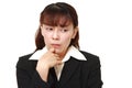 Unfashionable Asian businesswoman worries about something Royalty Free Stock Photo