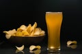 Unfiltered beer and potato chips in the bowl Royalty Free Stock Photo