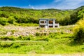 Unfinished abandoned gray concrete house in the side of a hill w