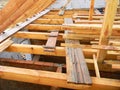 Unfinished attic house roofing construction trusses, wooden beams, eaves, timber. House roof wooden frame construction