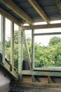 Unfinished attic wooden roof framing with vapor barrier, dormer and windows. View on timber rafters and beams on aerated concrete