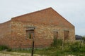 Unfinished bown bricks big house in green grass