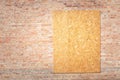 Unfinished red brick house wall with chipboard wood covered window frame. Royalty Free Stock Photo