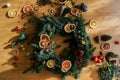 Unfinished Christmas wreath of pieces of dried fruits and berries lies on the floor. Top view