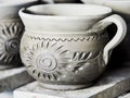 Unfinished clay pots on shelves as part of a ceramic pottery workshop in Marginea, Bucovina, Suceava county, Romania Royalty Free Stock Photo