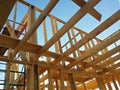 Unfinished construction of wooden house against blue sky