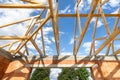 Unfinished country house with roof timber truss, support elements connected with beams and framework ceilings Royalty Free Stock Photo