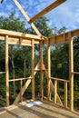 Unfinished country house. Wooden frame through which you can see the garden and the sunny blue sky. Summer outdoor photography