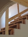 Unfinished drywall panel house walls and staircase wood frame