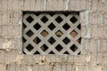 Unfinished family house wall made of large grey building blocks with opening covered with decorative concrete net