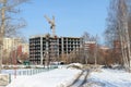 Unfinished high-rise apartment building and working crane Royalty Free Stock Photo