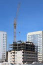 Unfinished high-rise building and working crane Royalty Free Stock Photo