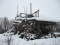 Unfinished house or cottage littered with snow. Scaffolding. Incomplete construction. Build a rural house with your own hands from Royalty Free Stock Photo