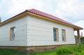 Unfinished house insulation ready for plastering wall with fiberglass mesh, plaster mesh, rigid foam insulation.